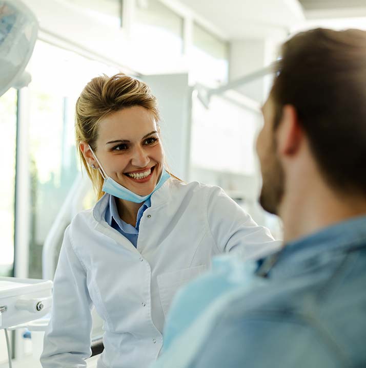 Dentist Smiling at Patient